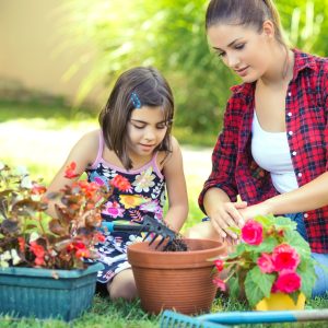 Mother's Day Garden Flowers. Mother and daughter planting flowers.